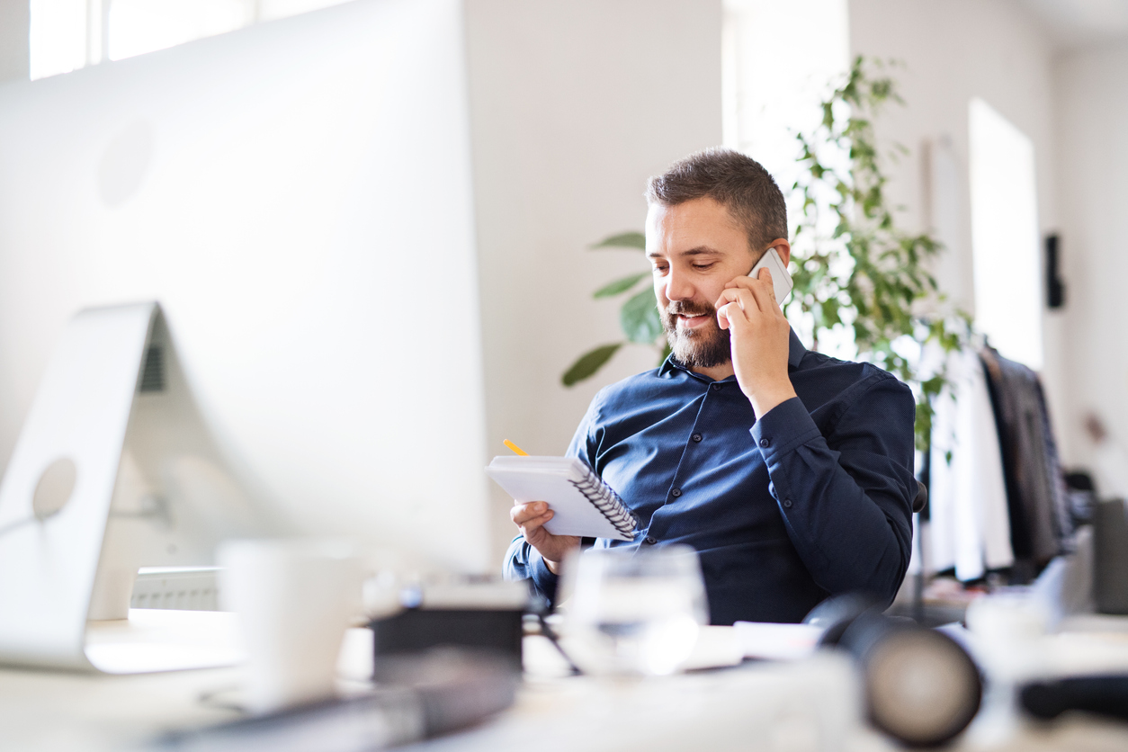 Businessman-in-wheelchair-at-the-desk-in-his-office.-913346608_1258x838