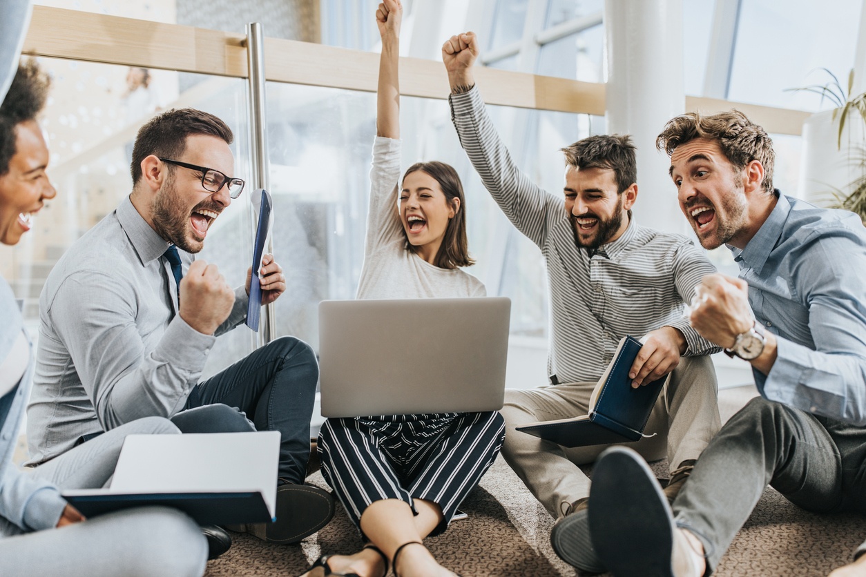 Group-of-joyful-business-colleagues-celebrating-their-success-at-casual-office.-953426614_1258x838