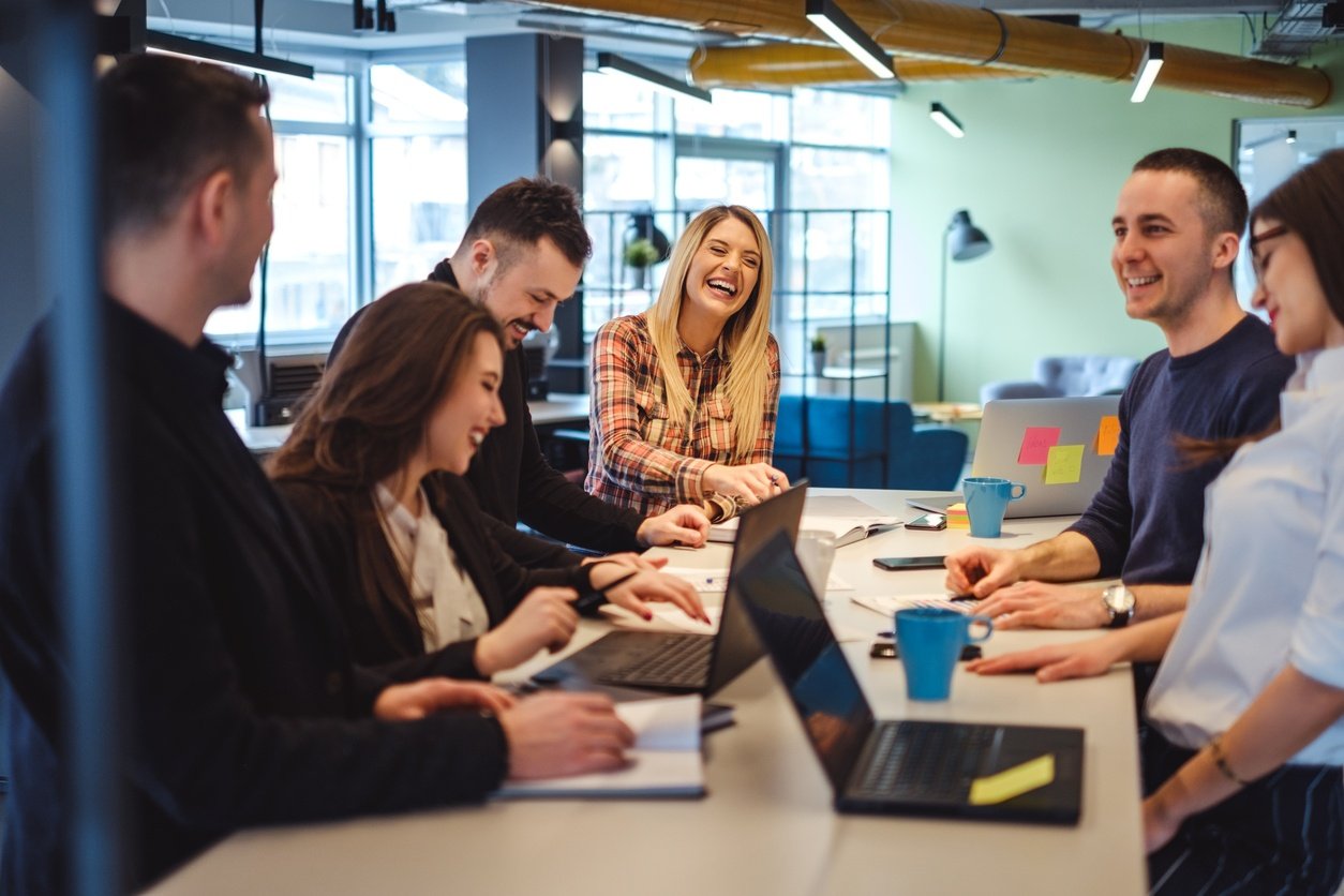 Happy-colleagues-laughing-in-the-office-meeting-961540536_1258x838